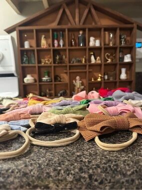 Assortment of baby bow headbands and macrame hanging bow organizer